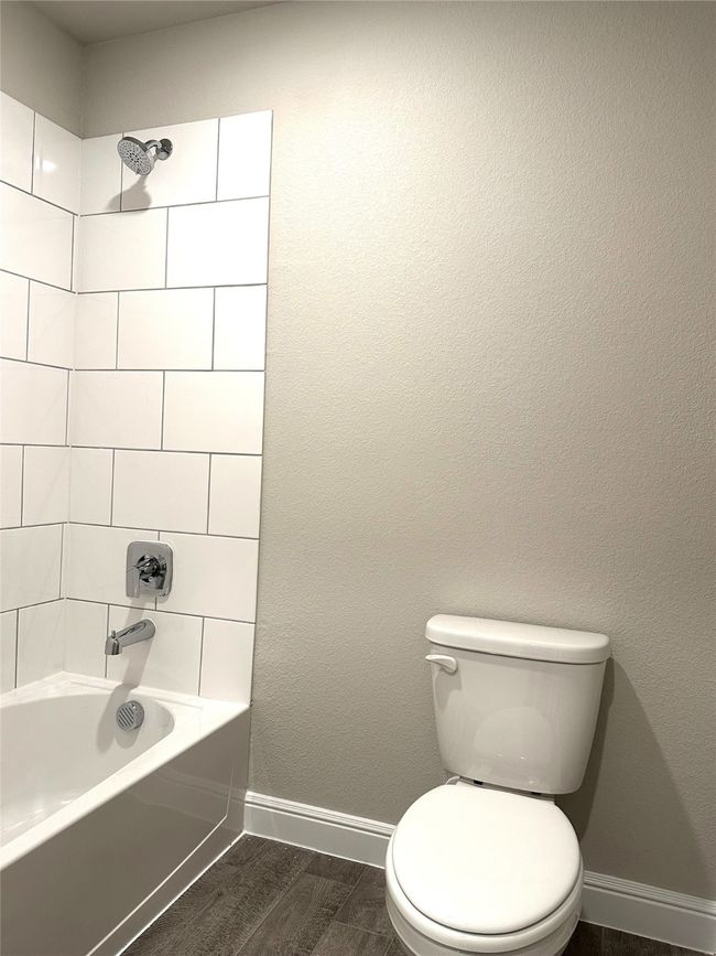 Full bath with shower / washtub combination and wood finished floors | Image 15