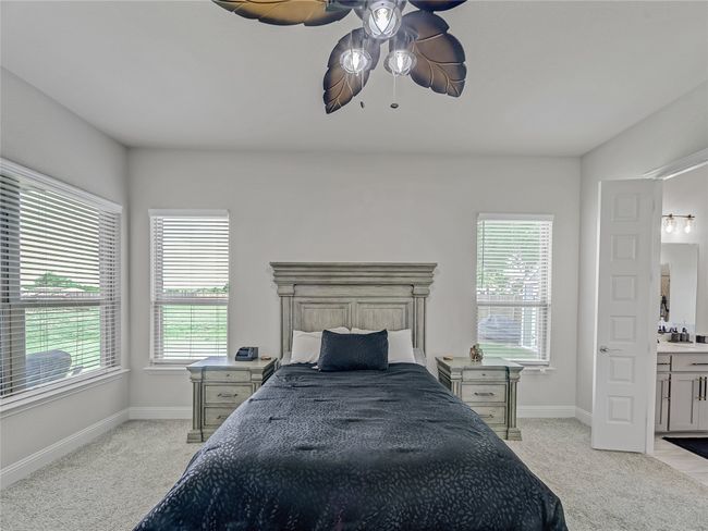 Bedroom with light colored carpet and multiple windows | Image 21