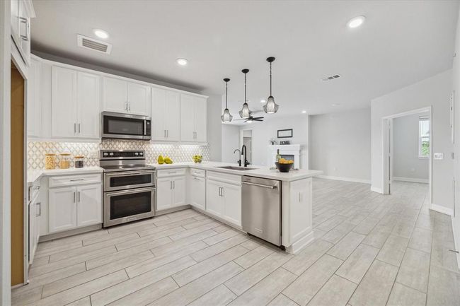 The kitchen seamlessly flows into the living room - ideal for entertaining. | Image 5