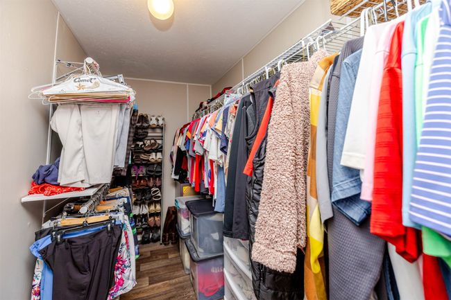 Walk in closet featuring wood finished floors | Image 22