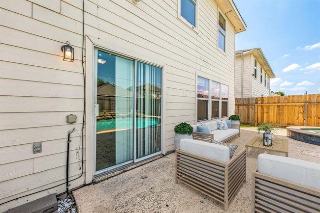 Step out onto this inviting patio space, perfect for outdoor lounging and entertaining with a view of the sparkling pool and spa. The ideal setting for summer gatherings or peaceful mornings. *Virtually Staged | Image 22
