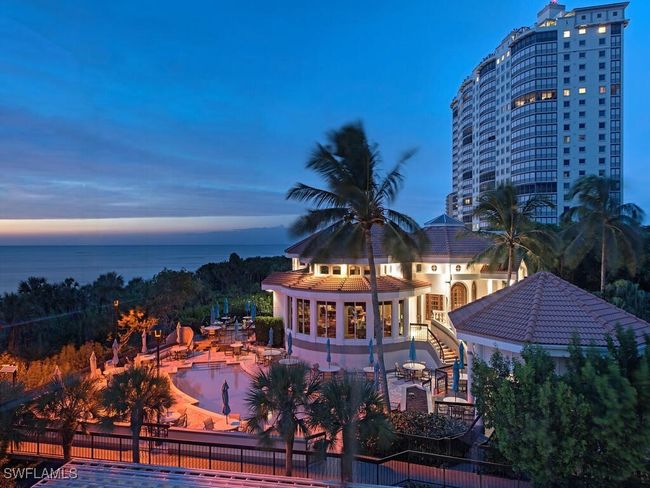 Bay Colony Beach Club Pool at dusk with a patio area and beach view! | Image 30