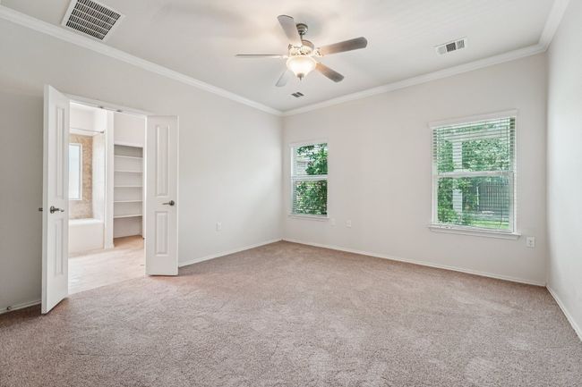 Unfurnished room featuring carpet, ceiling fan, ornamental molding, and baseboards | Image 21