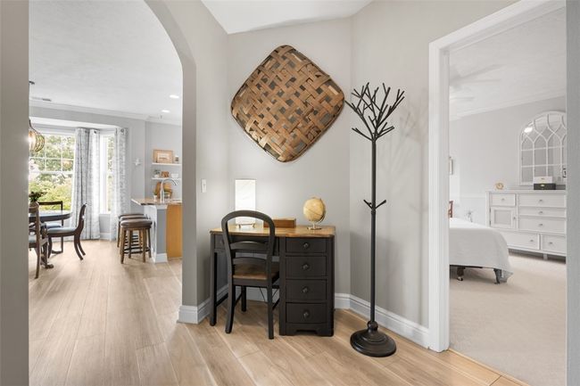 Upstairs you are greeted by beautiful vinyl plank flooring that flows throughout much of the level. This corner nook is perfect for a home office space as well. | Image 8
