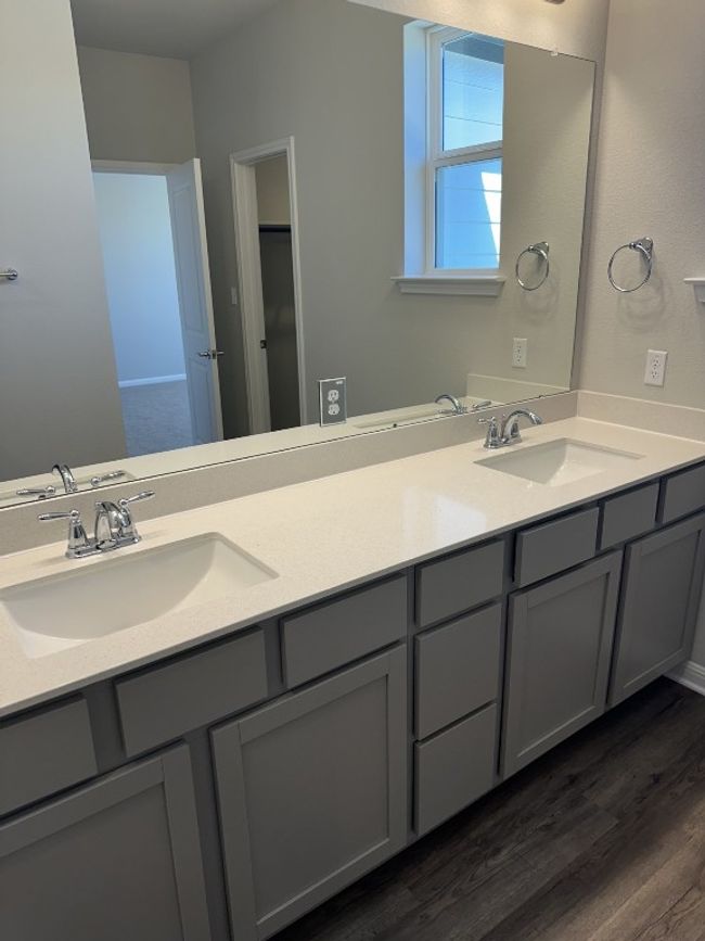 Bathroom featuring double vanity, a sink, and wood finished floors | Image 11