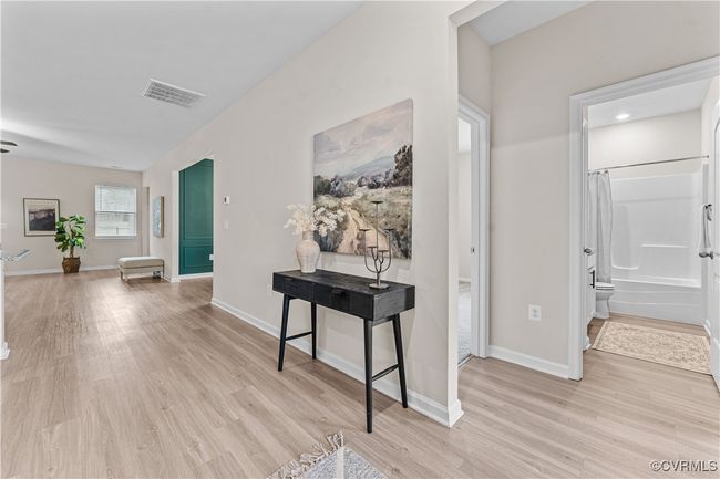 Corridor with light wood-style flooring and baseboards | Image 9