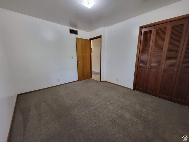 Unfurnished bedroom featuring carpet floors and a closet | Image 6