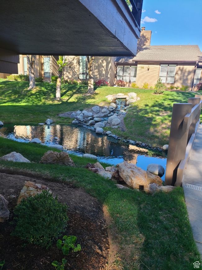 View of green lawn featuring a garden pond | Image 34
