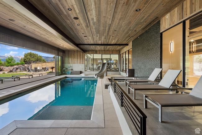 Swimming pool featuring a water slide and a mountain view | Image 64