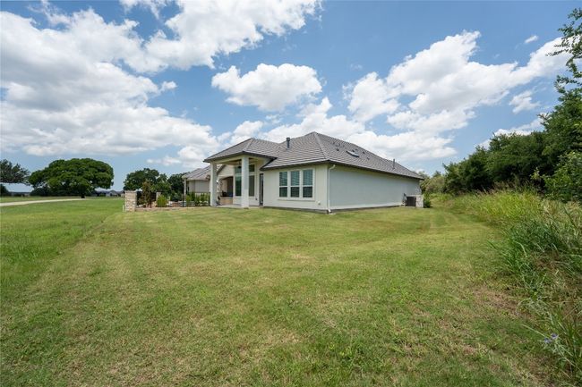 View of front of property with a front yard, a tile roof, and stucco siding | Image 33