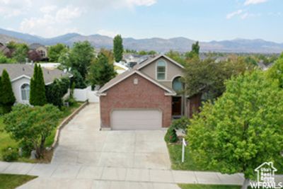 View of front of property with a mountain view and a garage | Image 1