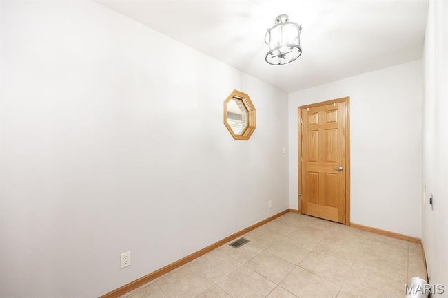 Unfurnished room featuring baseboards and light tile patterned floors | Image 30