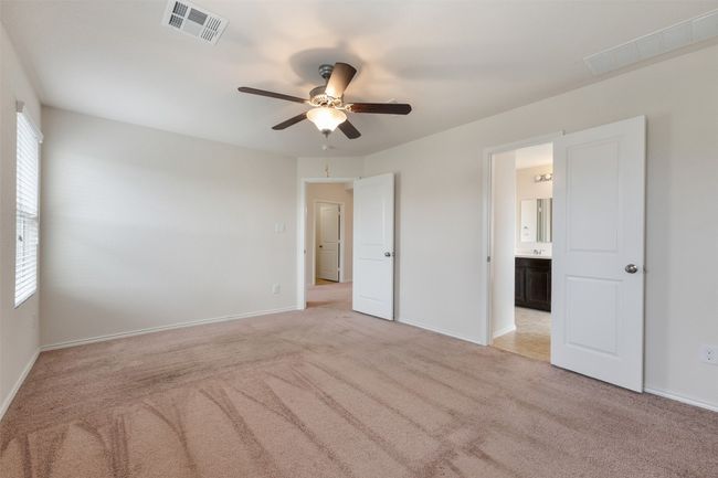 Unfurnished bedroom with light colored carpet, multiple windows, and baseboards | Image 25