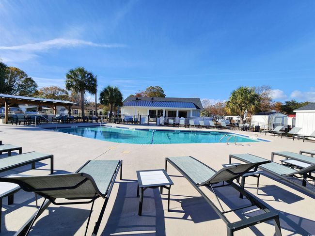 View of pool with a patio area | Image 35