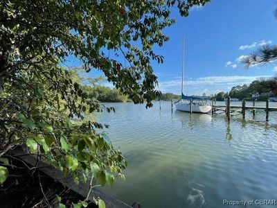 Dock area featuring a water view | Image 1