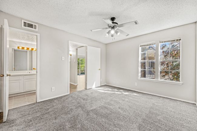 Unfurnished bedroom featuring baseboards, visible vents, carpet floors, and a textured ceiling | Image 8