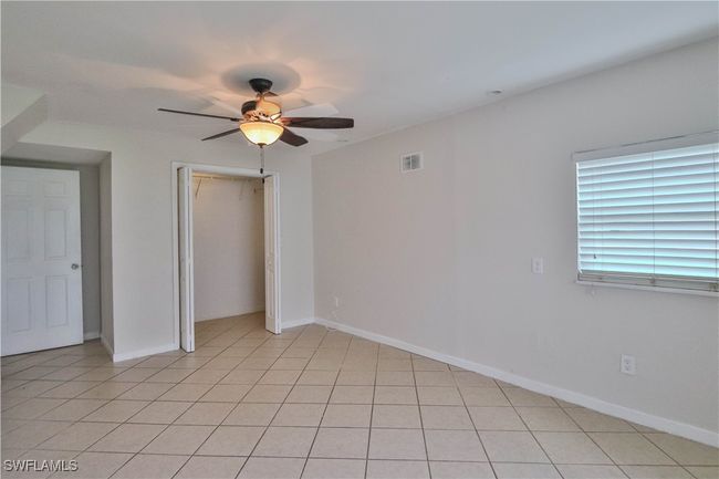 Unfurnished bedroom featuring a closet, a ceiling fan, and baseboards | Image 14