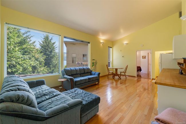 Living room featuring light wood-style floors and lofted ceiling | Image 40