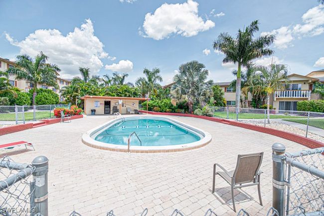 Community pool with fence and a patio area | Image 25