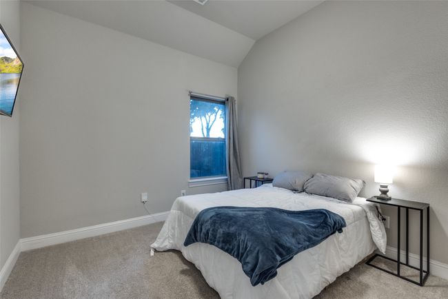 Bedroom with vaulted ceiling, carpet floors, and baseboards | Image 24