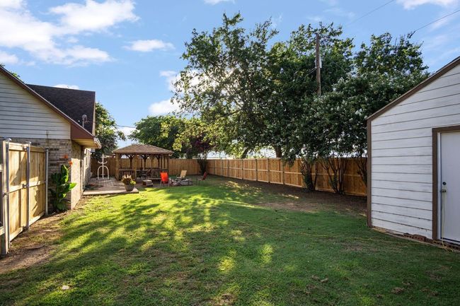 Fenced backyard featuring a gazebo | Image 25