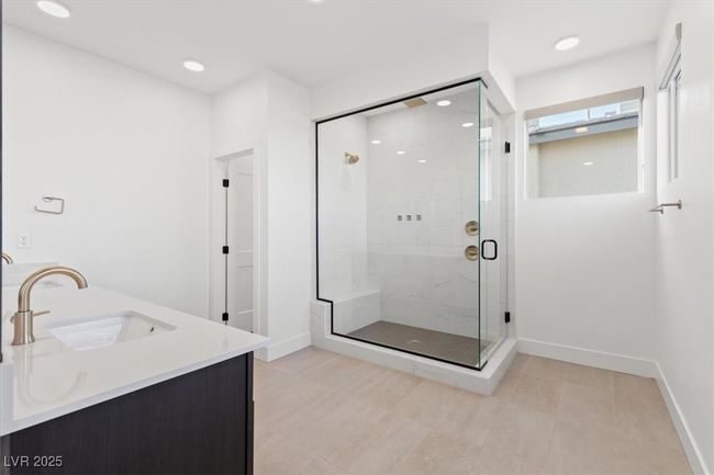 Full bath featuring a stall shower, recessed lighting, a sink, and baseboards | Image 40