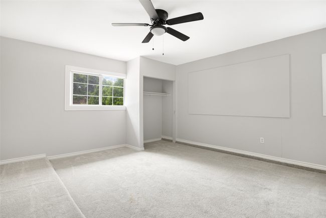 Converted garage space with carpet and ceiling fan | Image 18