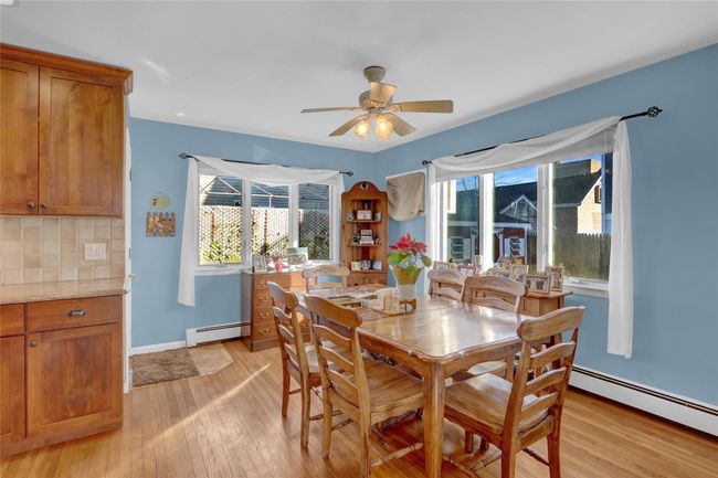 Dining space with ceiling fan, light hardwood / wood-style floors, and a baseboard heating unit | Image 13