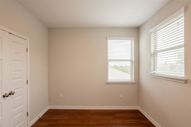Unfurnished room with baseboards, dark wood-style floors, and plenty of natural light | Image 20