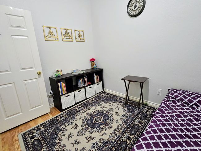 Bedroom with baseboards and wood finished floors | Image 25