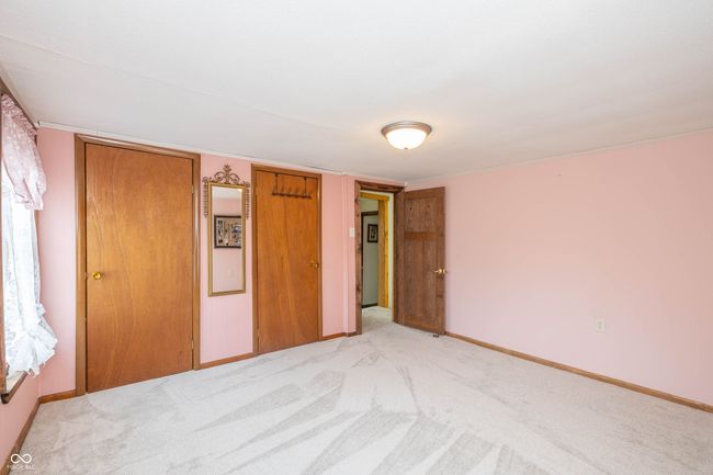 unfurnished bedroom featuring a closet, baseboards, and light carpet | Image 12