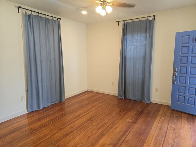 Empty room featuring ceiling fan and wood-type flooring | Image 9
