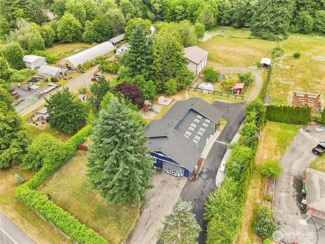fruit trees, chicken coops, large garden with potting shed, fenced acreage, RV parking, and a creek. | Image 37