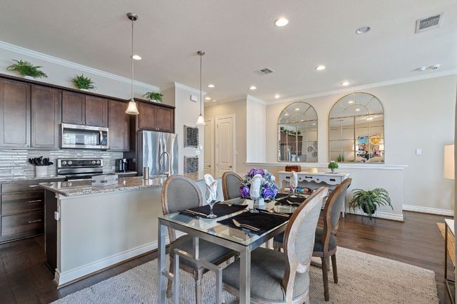 2nd Floor Dining area with dark wood-style floors, crown molding, and baseboards | Image 11