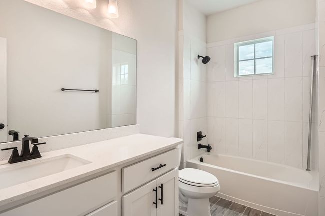 Full bathroom featuring toilet, vanity, bathing tub / shower combination, and wood finished floors | Image 22