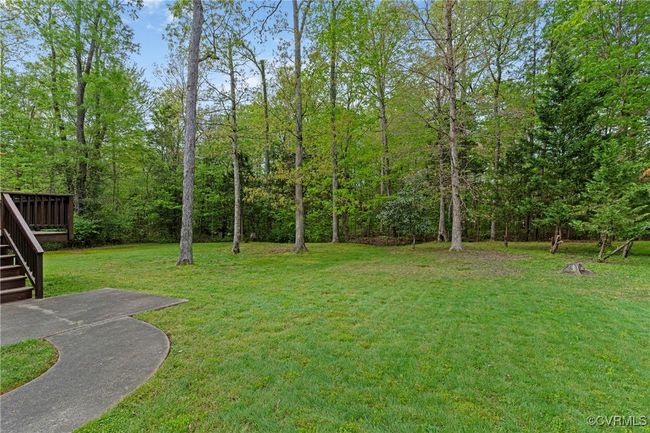 View of yard featuring stairs and a wooden deck | Image 42