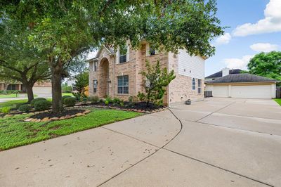 Drive up to your three car garage and extended driveway. | Image 3