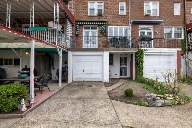 View of front of home featuring a garage, cooling unit, driveway, and brick siding | Image 17