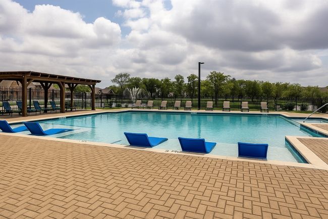 Pool with a patio area and fence | Image 23