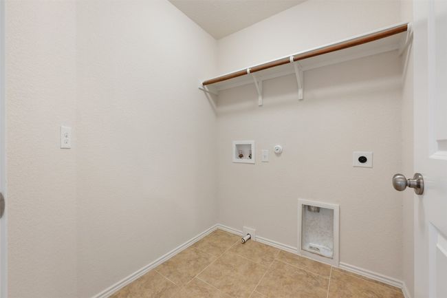 Laundry area featuring gas dryer hookup, hookup for a washing machine, hookup for an electric dryer, and baseboards | Image 31