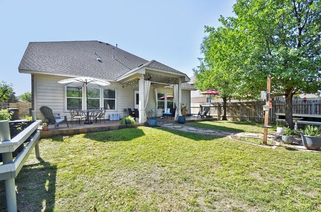 Views of the back exterior and extended patio space. | Image 30
