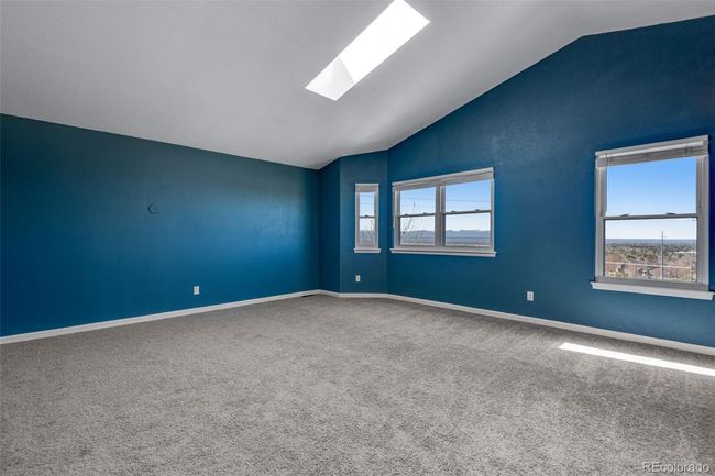 Unfurnished room with vaulted ceiling with skylight, baseboards, and carpet flooring | Image 17
