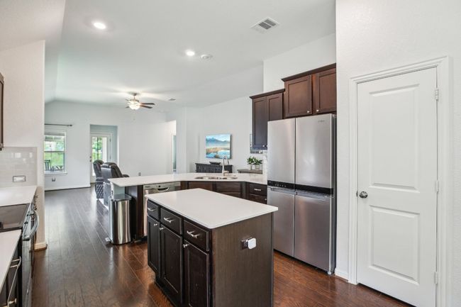 Kitchen with a sink, ceiling fan, a peninsula, and freestanding refrigerator | Image 14