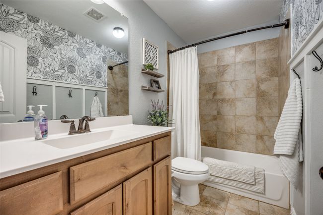 Full bathroom with vanity, toilet, and shower / bath combo | Image 19