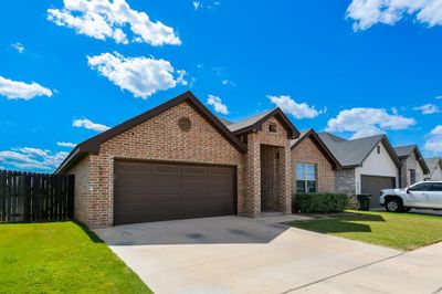 View of front of house featuring a garage and a front lawn | Image 3