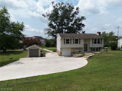 Split foyer home with an outdoor structure and a front lawn | Image 2