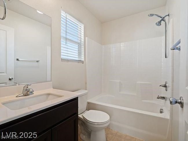 Full bathroom with shower combination, vanity, and light tile patterned floors | Image 18