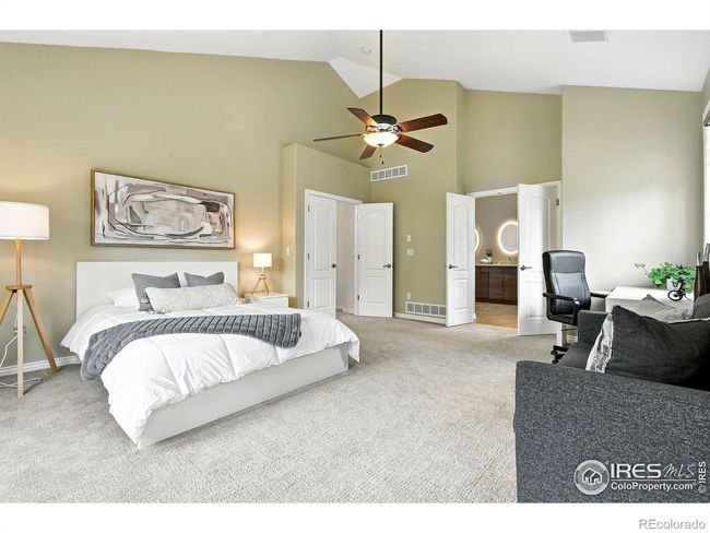French doors open to the primary bedroom that is large enough for a cozy sitting area. | Image 9