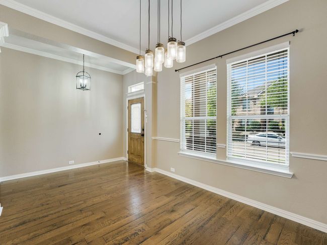 Unfurnished dining area with wood finished floors and crown molding | Image 4