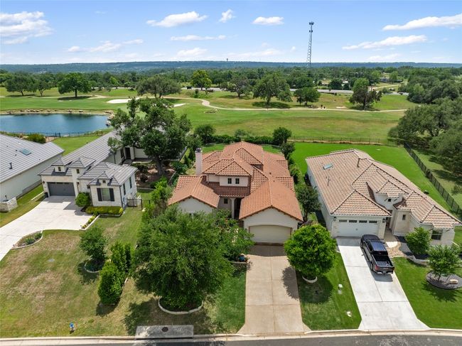 Birds eye view of property with view of golf course and a water view. | Image 39